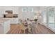 Cozy dining area featuring a round table with wood floors and natural light from the door at 427 Bluffs View Ln, Canton, GA 30114