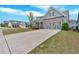 Charming home with grey siding, well-manicured lawn, and a long driveway to the attached two-car garage at 427 Bluffs View Ln, Canton, GA 30114