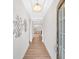 Bright and airy hallway with hardwood floors and decorative wall art leading to living space at 427 Bluffs View Ln, Canton, GA 30114