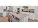 Modern kitchen island with granite countertops, stainless steel appliances, and bar stool seating at 427 Bluffs View Ln, Canton, GA 30114