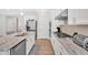 Bright kitchen features stainless steel appliances, granite countertops, and white cabinetry at 427 Bluffs View Ln, Canton, GA 30114