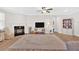 Spacious living room with fireplace, ceiling fan, and wood-look flooring at 427 Bluffs View Ln, Canton, GA 30114