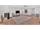 Spacious living room featuring wood floors, fireplace, and an open design to the kitchen area at 427 Bluffs View Ln, Canton, GA 30114