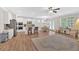 Bright and airy living space with wood floors, a ceiling fan, and a view of the kitchen and dining area at 427 Bluffs View Ln, Canton, GA 30114
