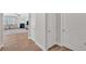 Open-concept living room with hardwood floors, fireplace, and ample natural light, adjacent to hallway at 427 Bluffs View Ln, Canton, GA 30114