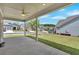 Covered patio with ceiling fan overlooking manicured backyard at 427 Bluffs View Ln, Canton, GA 30114