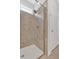 Walk-in shower with decorative tile surround, modern fixtures and glass door at 427 Bluffs View Ln, Canton, GA 30114