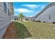 The side yard features a lush lawn with trees, landscaping, and an exterior view of the home at 427 Bluffs View Ln, Canton, GA 30114