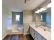 Bathroom with double sink vanity, soaking tub, and modern fixtures, offering a spa-like experience at 1575 Wynfield Dr, Auburn, GA 30011