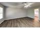 Bright bedroom with ceiling fan, laminate flooring, and a view of the ensuite bathroom, perfect for relaxation at 1575 Wynfield Dr, Auburn, GA 30011