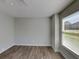 The bedroom has modern gray paint and floors, and a window with blinds at 1575 Wynfield Dr, Auburn, GA 30011