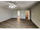 Relaxing bedroom featuring ceiling fan, laminate flooring, and easy access to the ensuite bathroom and closet at 1575 Wynfield Dr, Auburn, GA 30011