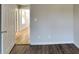 The bedroom offers modern gray paint, wood-look floors, and a view to the hall at 1575 Wynfield Dr, Auburn, GA 30011