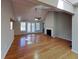 Bright living room with hardwood floors, fireplace, ceiling fan, and abundant natural light from large windows at 1575 Wynfield Dr, Auburn, GA 30011