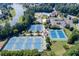 Beautiful aerial view of tennis courts, lake, playground, pool, and community clubhouse at 1739 Praters Pt, Dacula, GA 30019