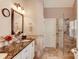 Elegant bathroom featuring a glass-enclosed shower, dual sinks and marble countertops at 1739 Praters Pt, Dacula, GA 30019
