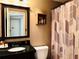 Bathroom featuring a dark vanity, a framed mirror, and a shower with a patterned curtain at 1739 Praters Pt, Dacula, GA 30019