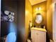 Stylish half bathroom featuring an oval mirror, modern vanity, and elegant decor, perfect for guests at 1739 Praters Pt, Dacula, GA 30019