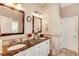 Elegant bathroom featuring dual sinks, marble countertops, and framed mirrors at 1739 Praters Pt, Dacula, GA 30019