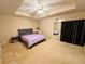 Spacious bedroom with a tray ceiling, ceiling fan, and neutral carpeting at 1739 Praters Pt, Dacula, GA 30019