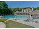 Beautiful community pool with lounge chairs and umbrellas, perfect for relaxing by the water at 1739 Praters Pt, Dacula, GA 30019