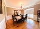 Elegant dining room featuring hardwood floors, wainscoting, and ample natural light at 1739 Praters Pt, Dacula, GA 30019