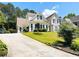 Charming home featuring a well-manicured lawn, lush landscaping, and traditional architectural details at 1739 Praters Pt, Dacula, GA 30019