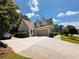 Charming home with a large driveway, a two car garage, and manicured landscaping at 1739 Praters Pt, Dacula, GA 30019