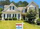 Charming home featuring a well-manicured lawn, lush landscaping, and traditional architectural details at 1739 Praters Pt, Dacula, GA 30019