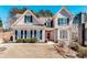 Charming home featuring a well-manicured lawn, lush landscaping, and traditional architectural details at 1739 Praters Pt, Dacula, GA 30019