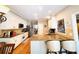 Well-lit kitchen with white cabinetry, granite countertops, stainless appliances, and a breakfast bar with seating at 1739 Praters Pt, Dacula, GA 30019