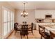 This is a kitchen and breakfast nook with white cabinets, granite counters, stainless appliances, and wood floors at 1739 Praters Pt, Dacula, GA 30019