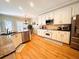 Eat-in kitchen features white cabinets, stainless appliances, and hardwood floors at 1739 Praters Pt, Dacula, GA 30019