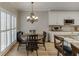 This is a kitchen and breakfast nook with white cabinets, granite counters, and wood floors at 1739 Praters Pt, Dacula, GA 30019