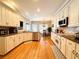 Eat-in kitchen features white cabinets, stainless appliances, and hardwood floors at 1739 Praters Pt, Dacula, GA 30019