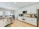 Eat-in kitchen features white cabinets, granite counters, and stainless appliances at 1739 Praters Pt, Dacula, GA 30019