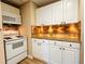 Kitchen featuring white appliances, and plenty of countertop space for cooking and entertaining at 1739 Praters Pt, Dacula, GA 30019