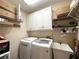 Functional laundry room equipped with washer, dryer, and plenty of storage space at 1739 Praters Pt, Dacula, GA 30019