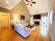Bright living room with vaulted ceilings, hardwood floors, and a cozy fireplace creating a welcoming space at 1739 Praters Pt, Dacula, GA 30019