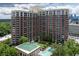 Overhead shot showcasing the residential building, green spaces, and outdoor pool area of the property at 1820 Peachtree St # 311, Atlanta, GA 30309