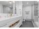 Modern bathroom with dual sinks, sleek white cabinetry, and a glass-enclosed shower at 1820 Peachtree St # 311, Atlanta, GA 30309