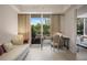 Inviting bedroom featuring a daybed, a desk, and large windows with lush green views at 1820 Peachtree St # 311, Atlanta, GA 30309
