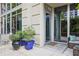 Welcoming entrance with potted plants, an outdoor seating area, and a glass front door at 1820 Peachtree St # 311, Atlanta, GA 30309