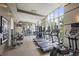 Well-equipped fitness center with treadmills, weight machines, and large windows offering natural light at 1820 Peachtree St # 311, Atlanta, GA 30309