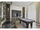 Well-lit game room featuring a pool table, lounge seating, and a large screen television at 1820 Peachtree St # 311, Atlanta, GA 30309