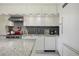 Modern kitchen with white cabinets, gray backsplash, stainless steel appliances, and granite countertop at 1820 Peachtree St # 311, Atlanta, GA 30309