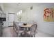 Modern white kitchen with stainless steel appliances, a center island, and an adjacent dining area at 1820 Peachtree St # 311, Atlanta, GA 30309