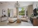 Inviting living room featuring a stylish light fixture, modern decor, and a comfortable sectional sofa at 1820 Peachtree St # 311, Atlanta, GA 30309