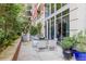 Comfortable patio area with a glass table, seating, and privacy provided by lush greenery at 1820 Peachtree St # 311, Atlanta, GA 30309