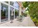 Beautiful patio featuring a table, chairs, greenery, and views of the building's architecture and surrounding trees at 1820 Peachtree St # 311, Atlanta, GA 30309